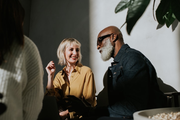 Black man and white woman happily talking