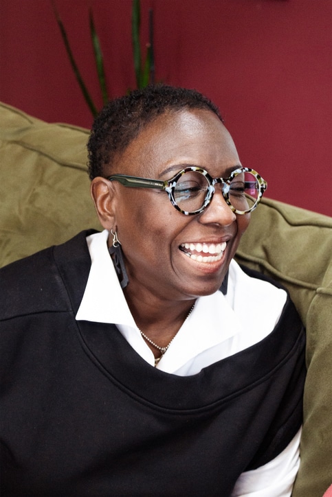 Mature Black woman with glasses laughing