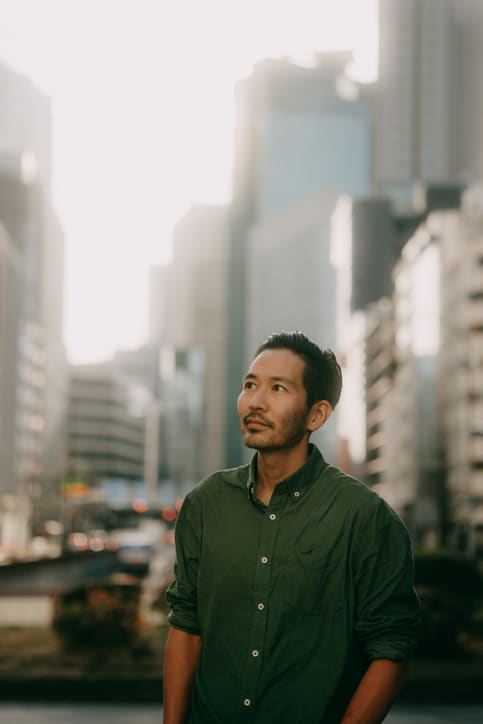 Asian man walking in a city