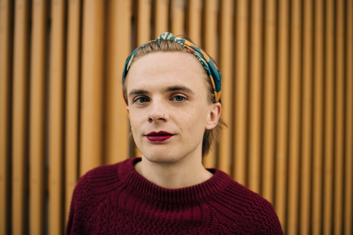 Portrait of a young white man wearing lipstick